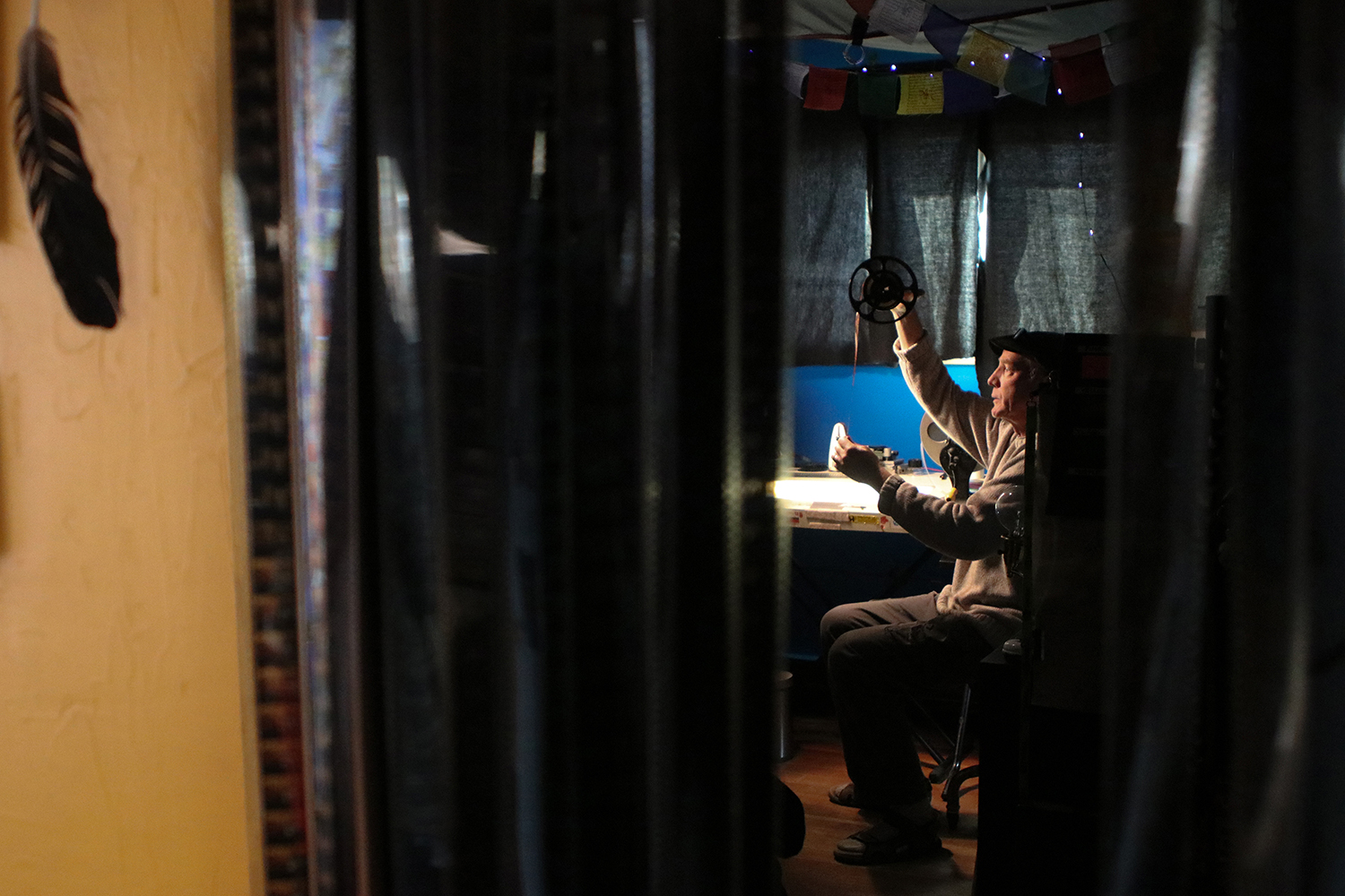 Canadian animator Richard Reeves examines a strip of film in his home studio in Creston, B.C., on Nov. 25, 2020. (Photo by Aaron Hemens for Creston Valley Advance)
