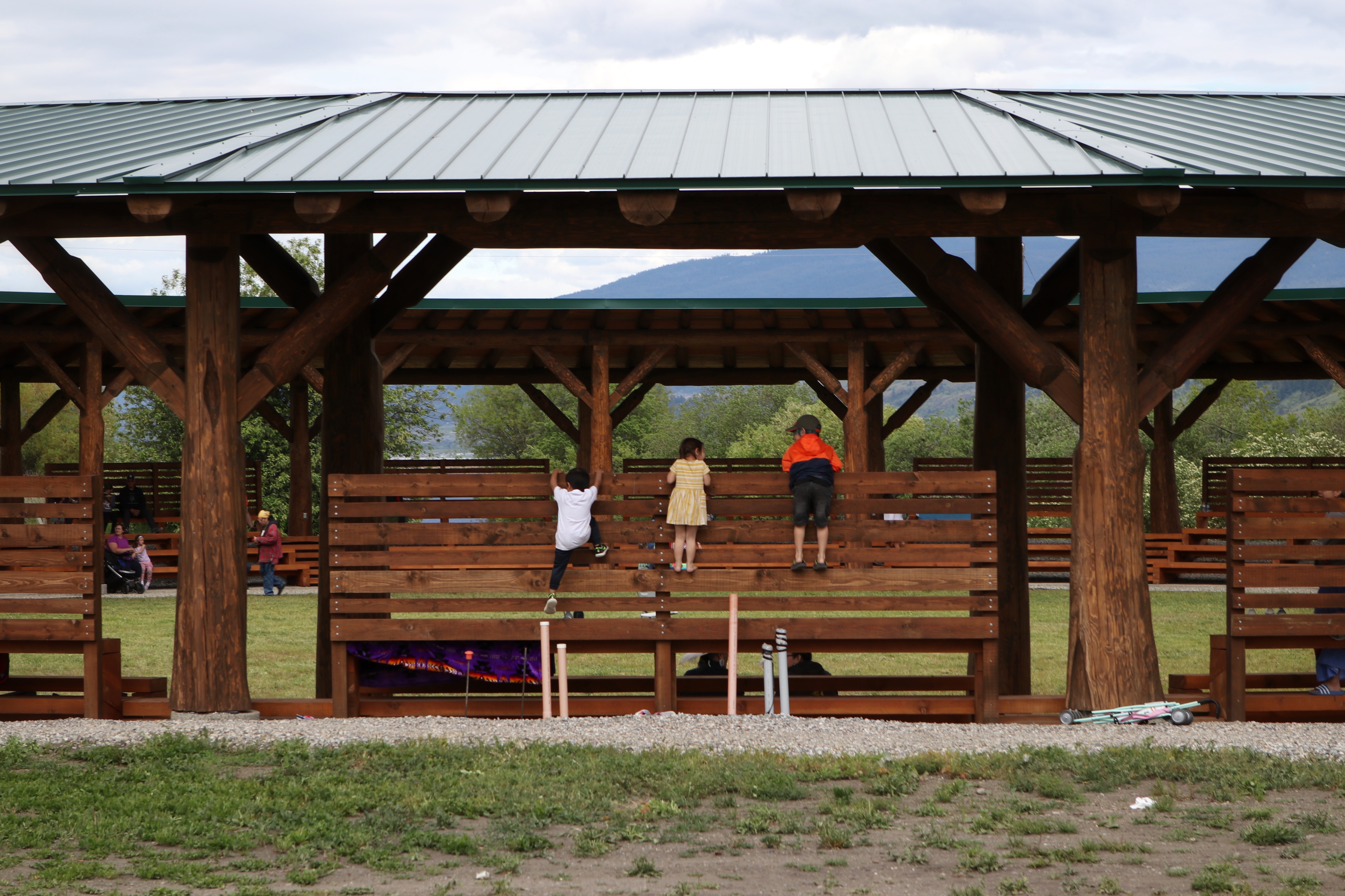 Youth play on the Okanagan Indian Band’s Cultural Arbor during its grand reopening event in syilx homelands on May 28, 2022. Photo by Aaron Hemens for IndigiNews