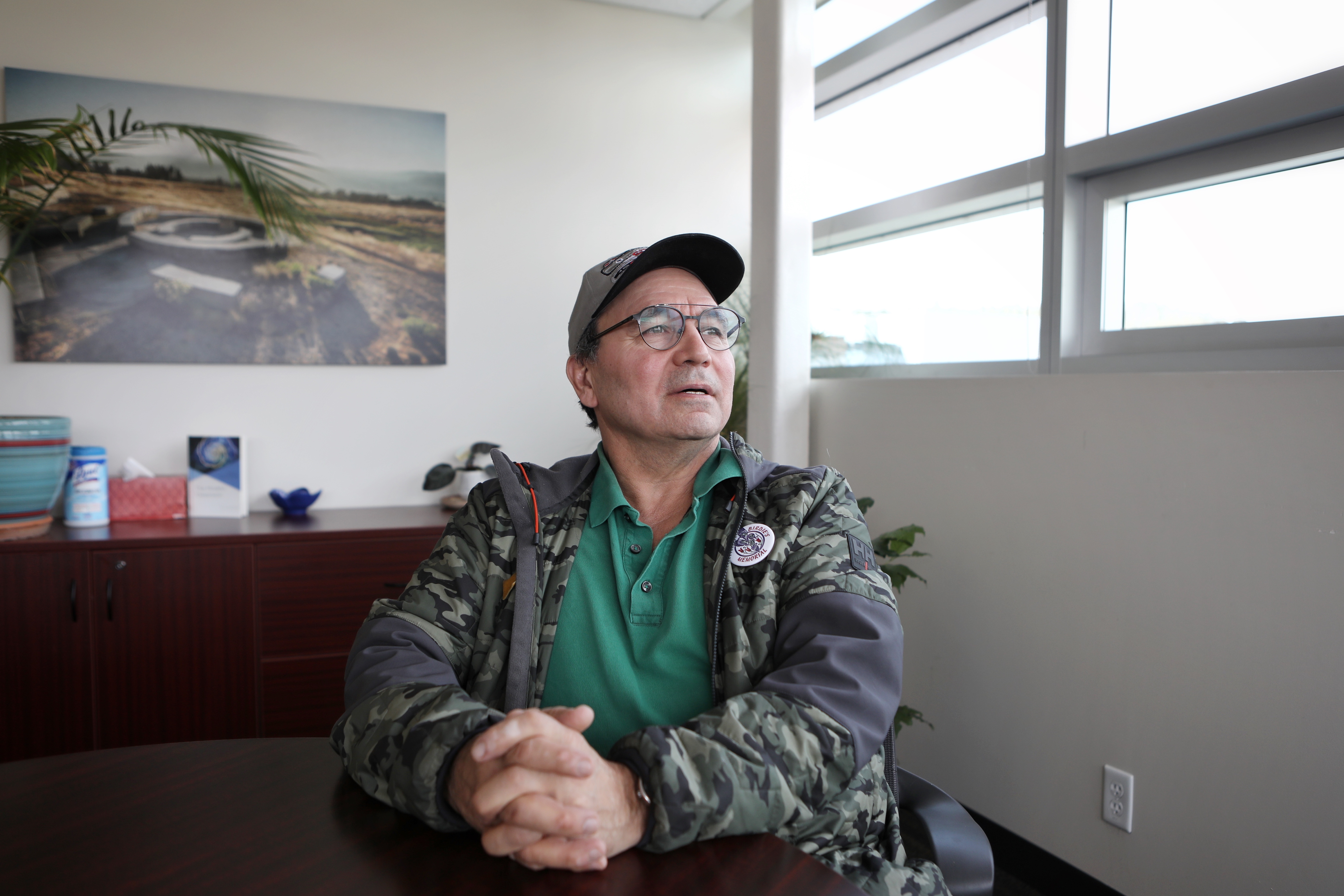 mhuya Bill Cohen, a syilx professor at UBC-Okanagan (UBCO) and a member of the Co-Curricular-Making research team, sits inside of a board room at the university in syilx homelands on March 10. Photo by Aaron Hemens