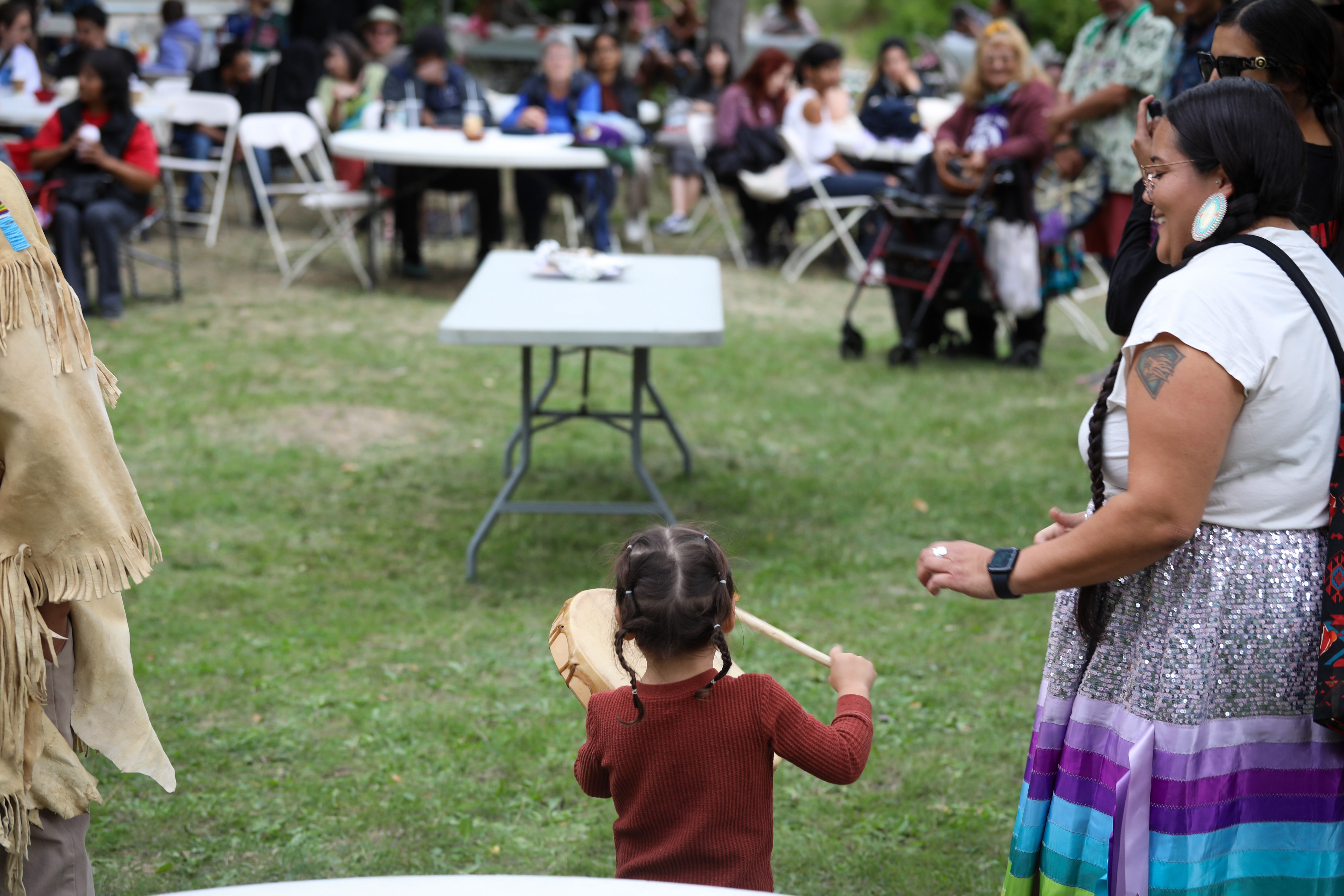 A young drummer plays at the syilx Okanagan Nation’s 2024 salmon feast and celebration at Okanagan Falls, B.C., on Sept. 22. For IndigiNews